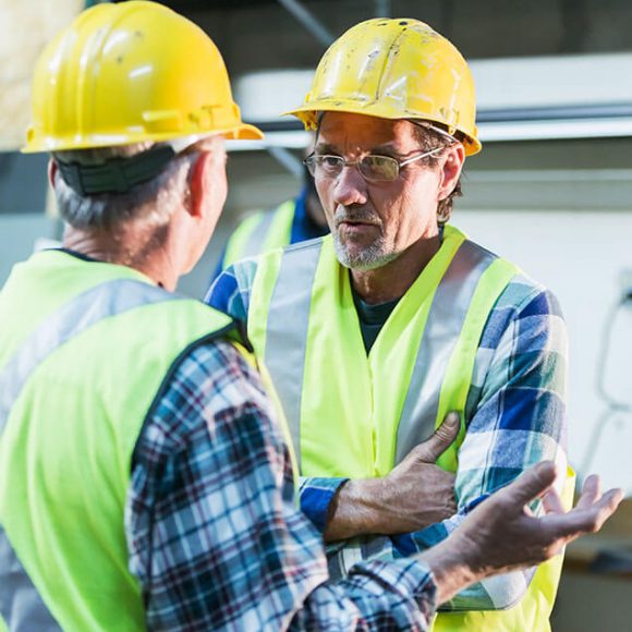 Picture of two men having a conversation on a job site