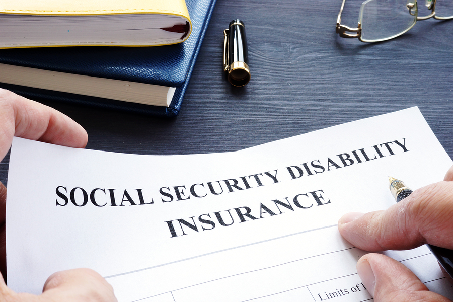 Photo of a Man Holding Social Security Disability Forms